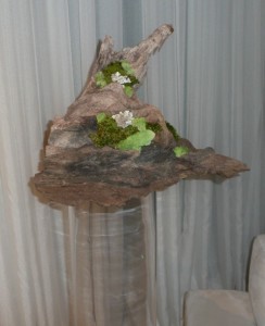 Driftwood paired with moss makes a great statement piece for event decor WM Events