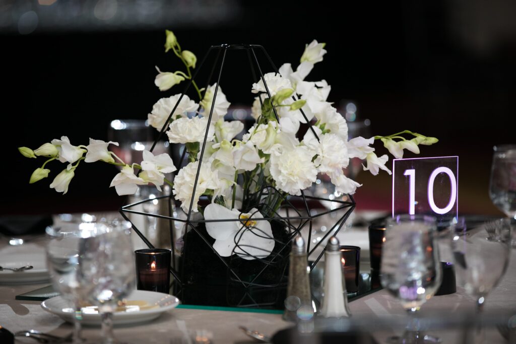 wm events, bulldog 100, university of georgia, uga, 2019 events, modern events, black and white, geometric design, event planner, event designer, hyatt regency events, atlanta events, georgia events, corporate events, social events, non-profit events, white floral, white flowers, custom centerpieces, table numbers, custom branding, ballroom, seated dinner, plated dinner